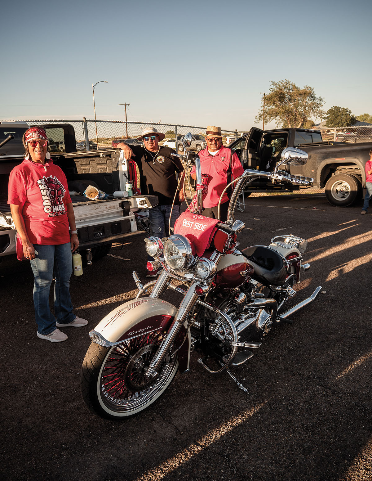 A group of men stand around a motorcycle